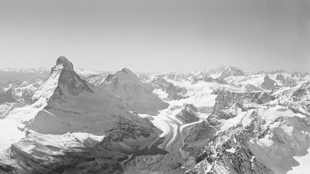 The aerial photograph from 1930 shows the Matterhorn with the Valais Alps.
