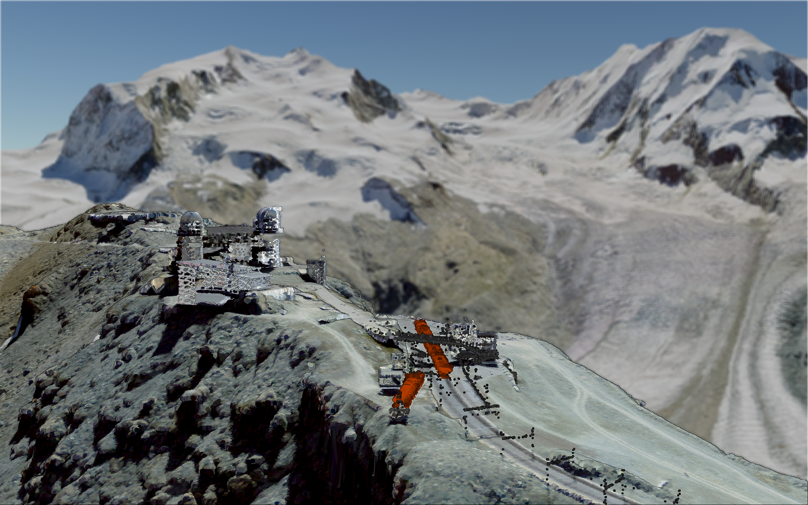 L'image montre l'observatoire du Gornergrat avec la gare du Gornergrat et le massif du Mont Rose en arrière-plan.