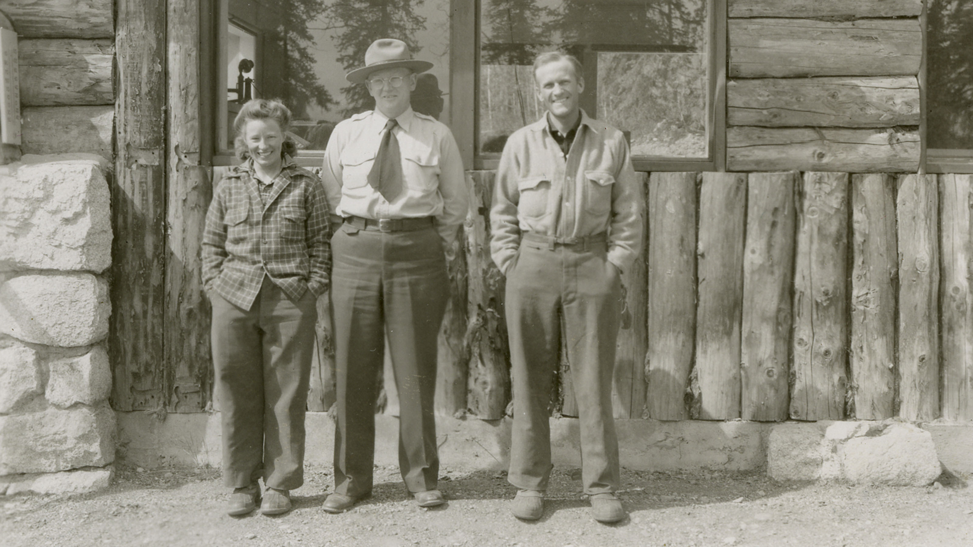 Barbara and Bradford Washburn stand in hiking gear next to McKinley National Park Superintendent Frank Been.