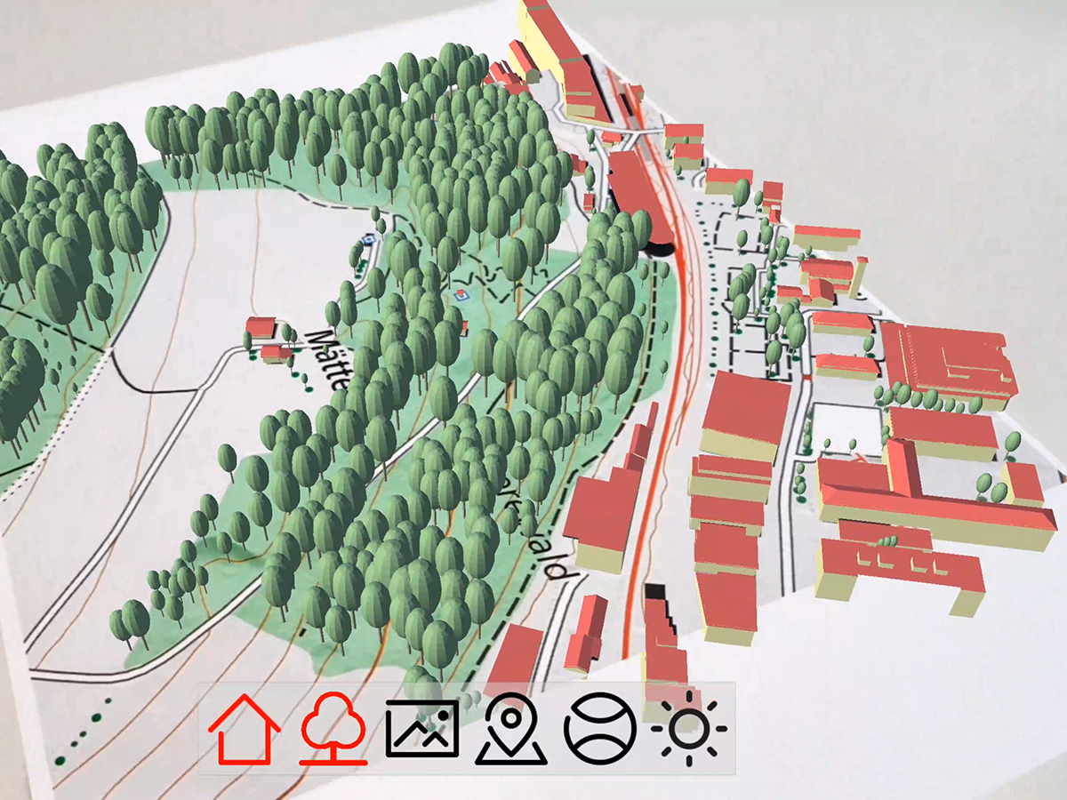 Overlay of digital 3D objects (trees and buildings) on a physical map section