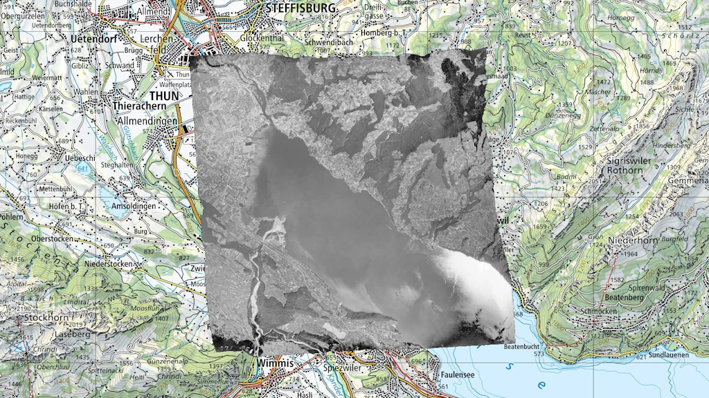 Orthophoto of swisstopo's black and white aerial image overlaid on the national map in a GIS application.