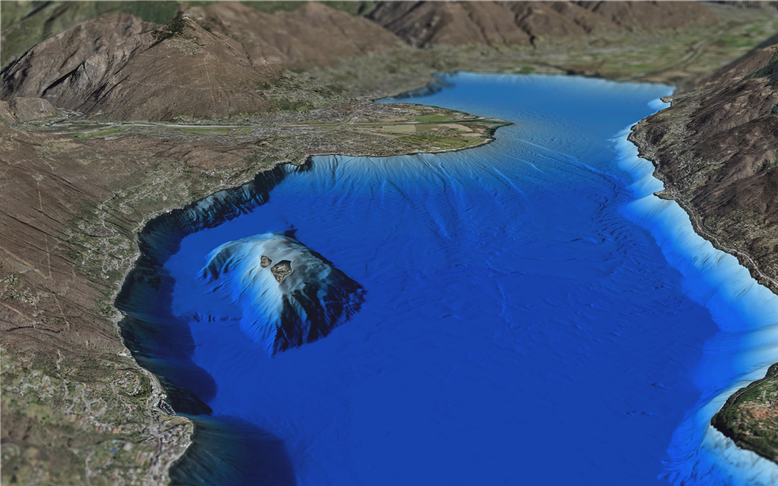 L'image montre le fond du lac Majeur avec les îles Brissago au premier plan et Locarno en arrière-plan, vu du côté italien.